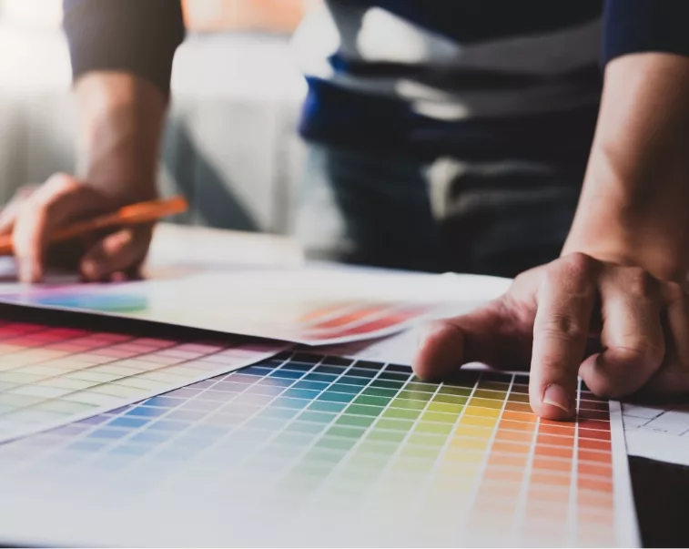 Brand guidelines designer looking through color swatches