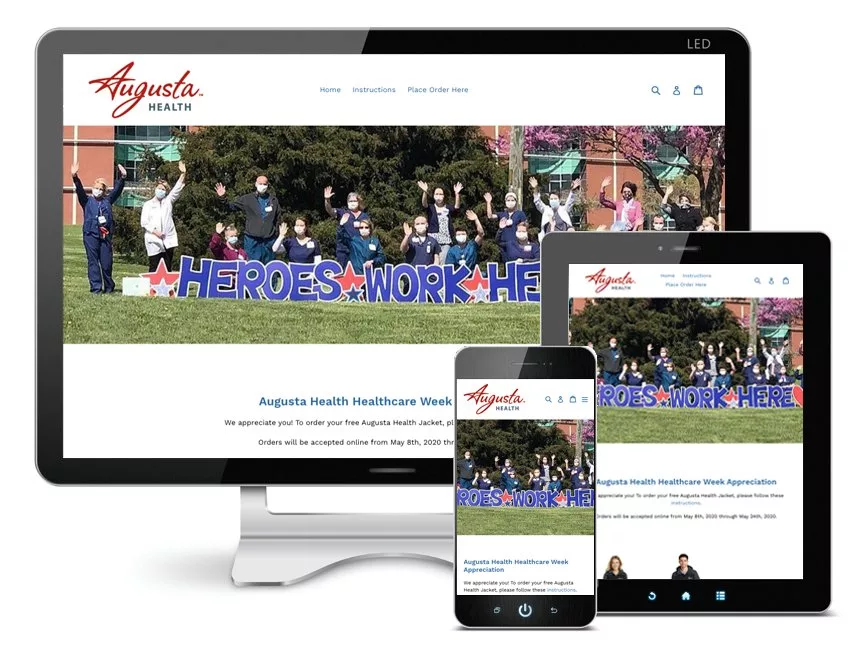 Augusta Health website displayed on a desktop, tablet, and smartphone. People with a "Heroes Work Here" sign are in the background.